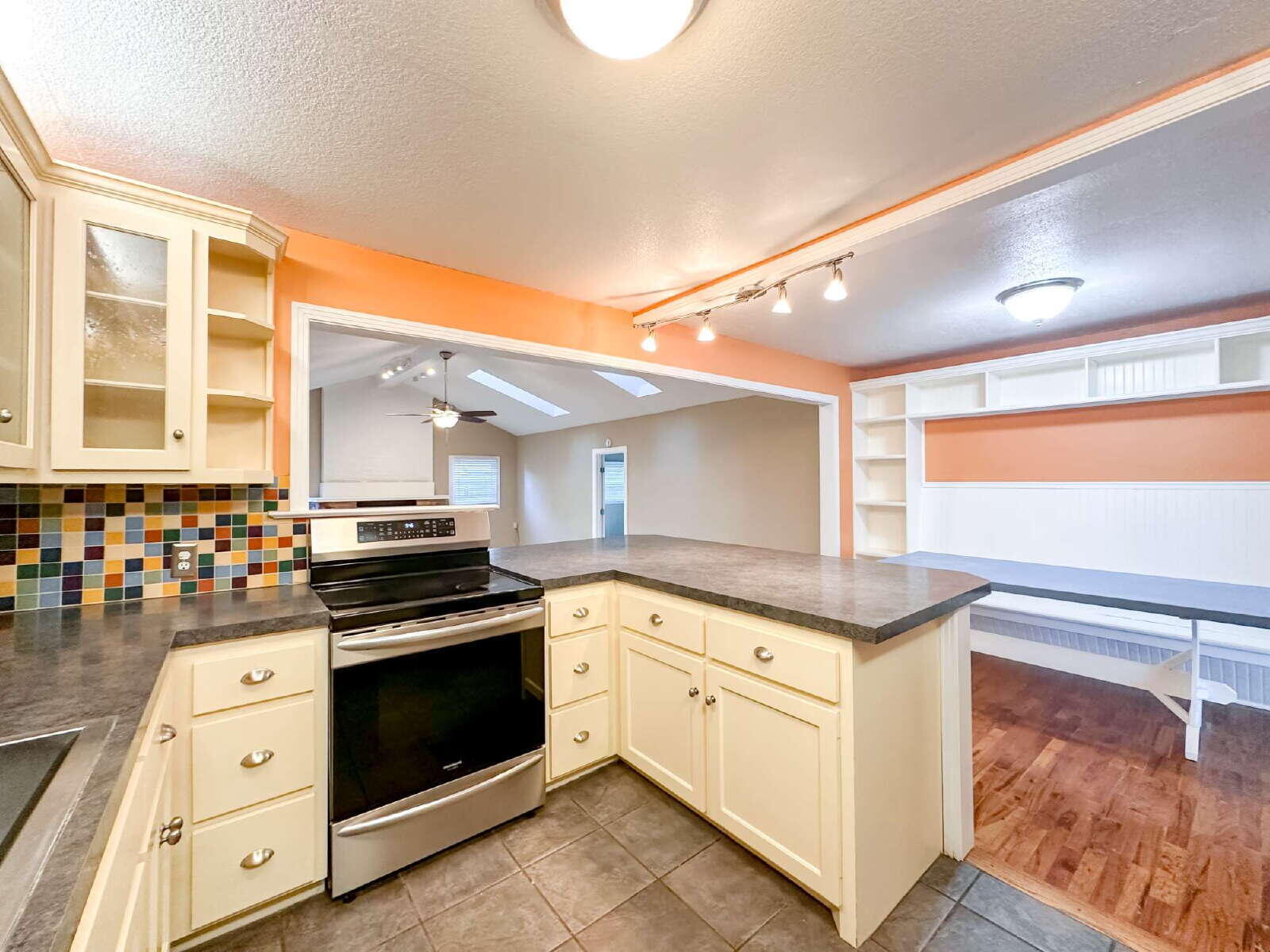 2614 32nd Street Lubbock, TX 79410 - Photo 11 of 37 a kitchen with granite countertop a stove top oven sink and cabinets