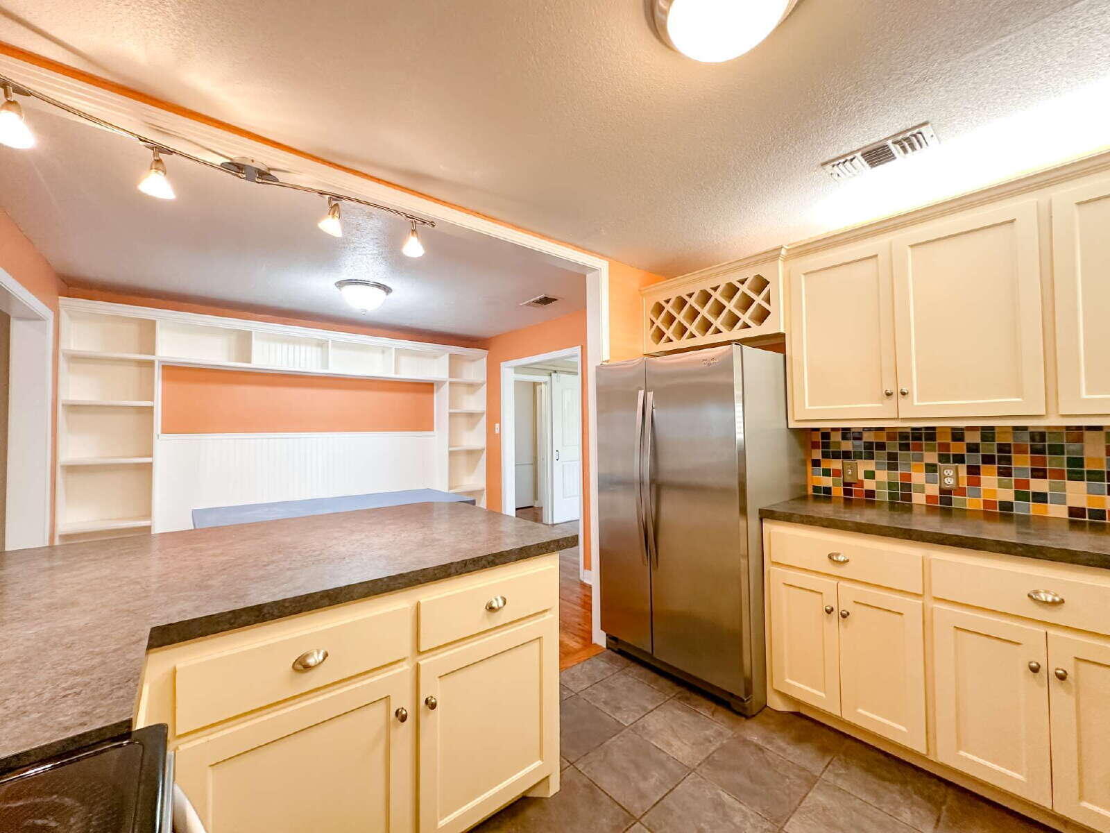 2614 32nd Street Lubbock, TX 79410 - Photo 12 of 37 a kitchen with granite countertop a sink and cabinets
