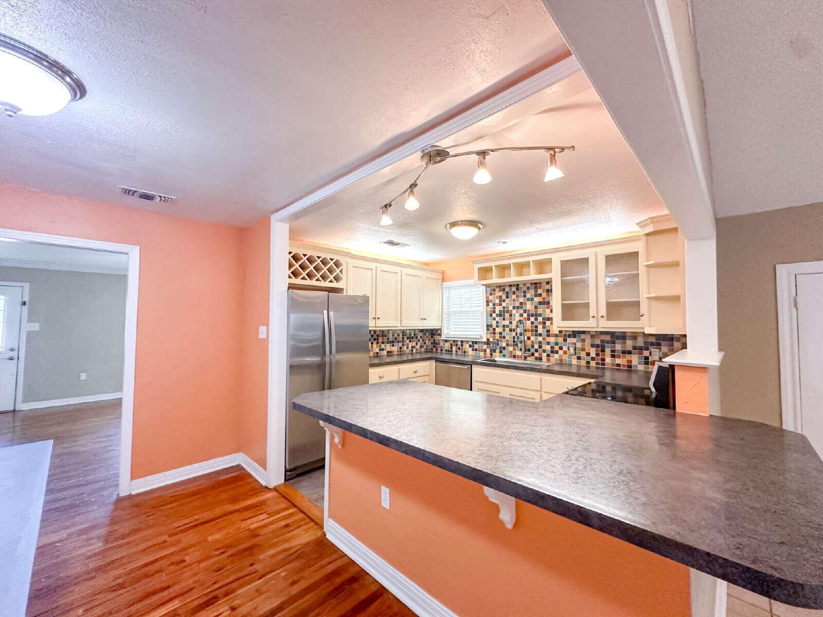 2614 32nd Street Lubbock, TX 79410 - Photo 13 of 37 a large kitchen with stainless steel appliances a large counter top and a wooden floors