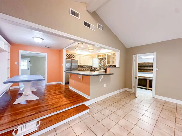 a kitchen with stainless steel appliances kitchen island granite countertop a refrigerator and stove