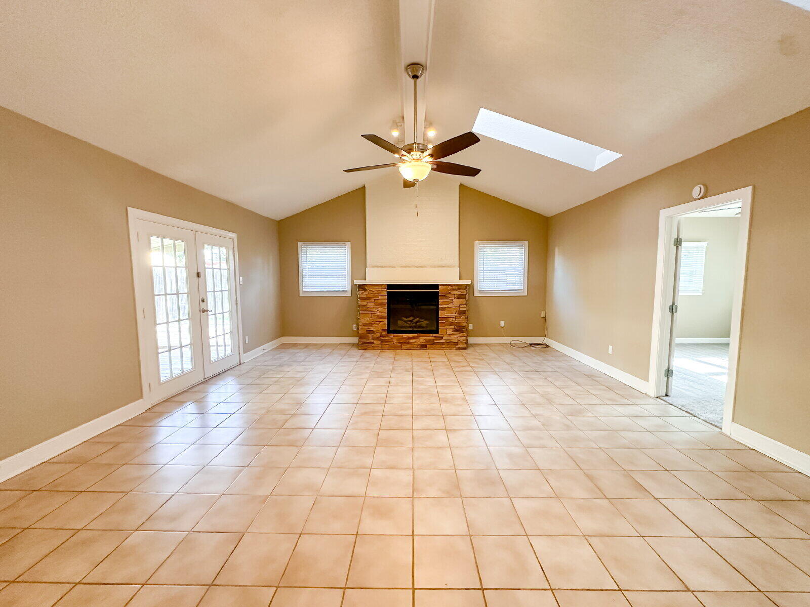 2614 32nd Street Lubbock, TX 79410 - Photo 19 of 37 a view of an empty room with window and chandelier fan