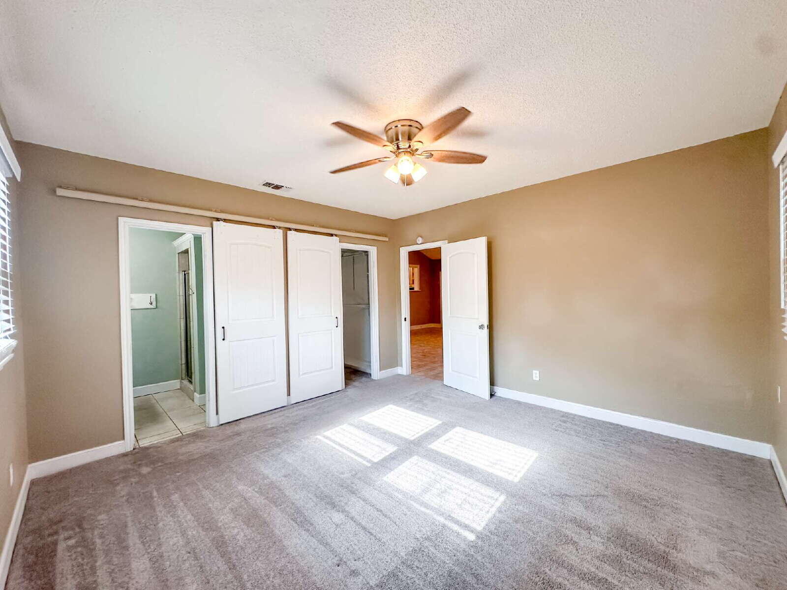 2614 32nd Street Lubbock, TX 79410 - Photo 26 of 37 a view of a big room with windows and chandelier fan