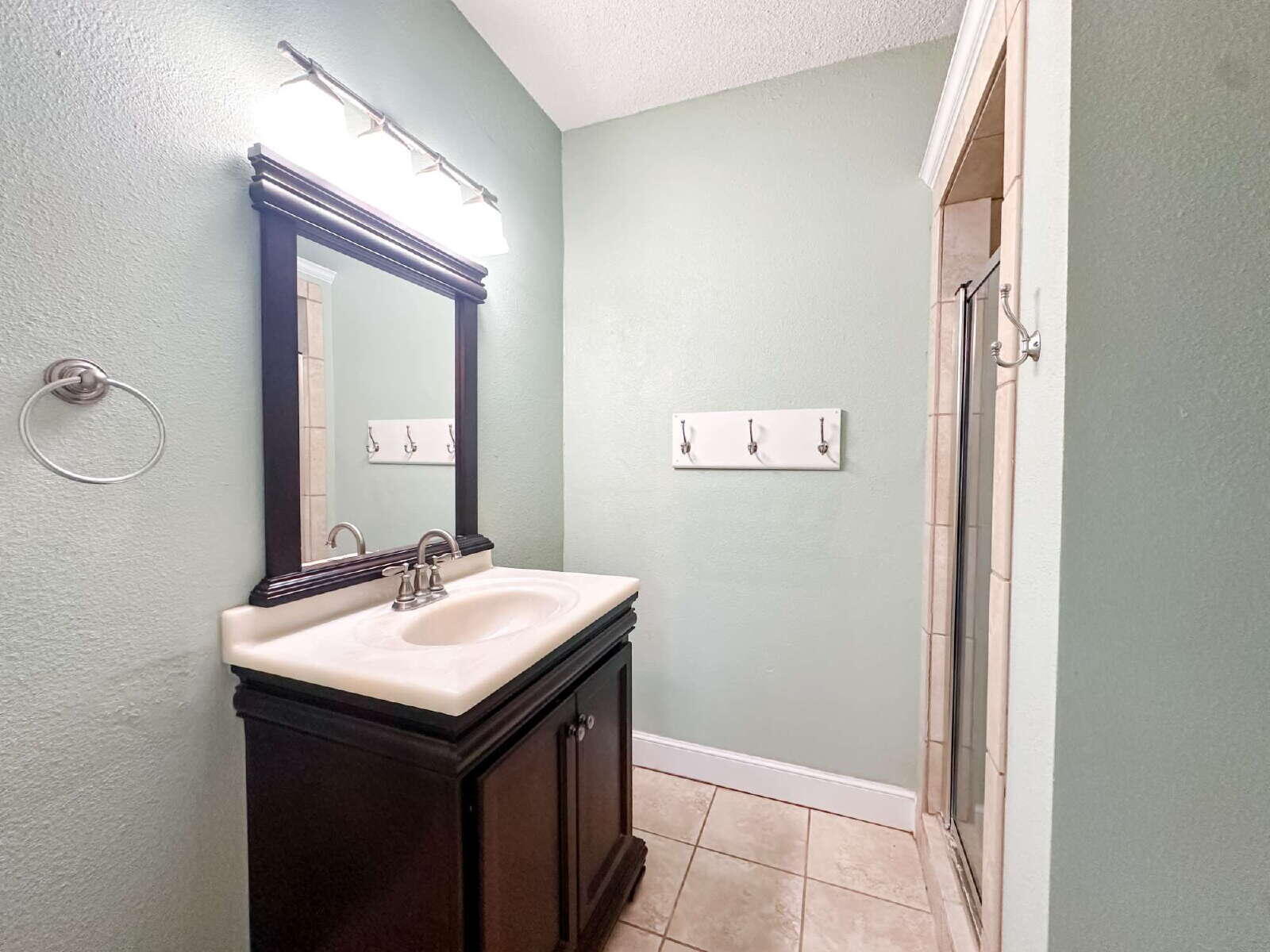 2614 32nd Street Lubbock, TX 79410 - Photo 27 of 37 a bathroom with a sink and a mirror