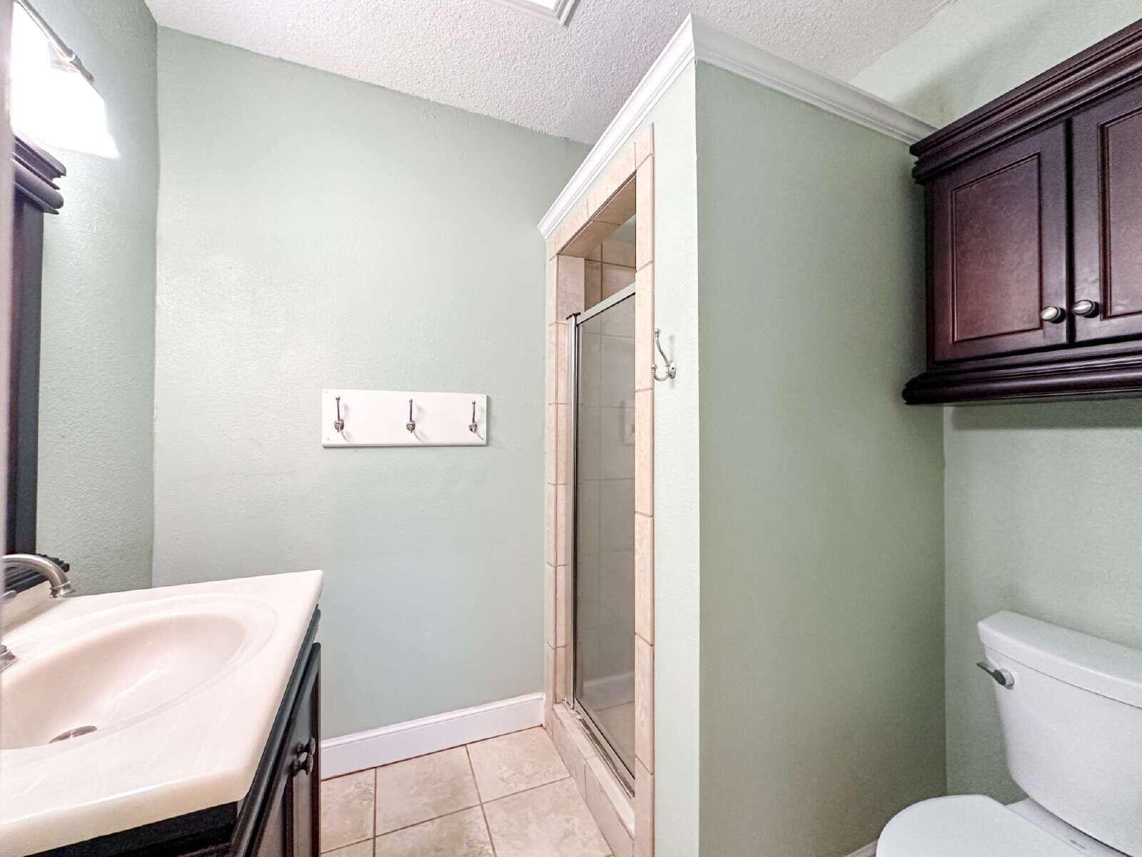 2614 32nd Street Lubbock, TX 79410 - Photo 28 of 37 a bathroom with a sink a toilet and a mirror