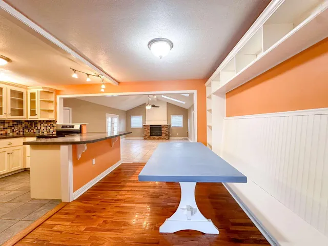 a kitchen with stainless steel appliances furniture stove top oven and cabinets