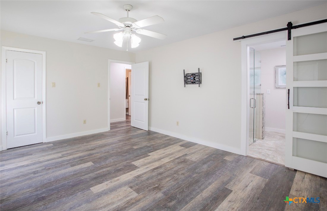 188 Cavalry Road Victoria, TX 77905 - Photo 9 of 30 wooden floor in an empty room with a window