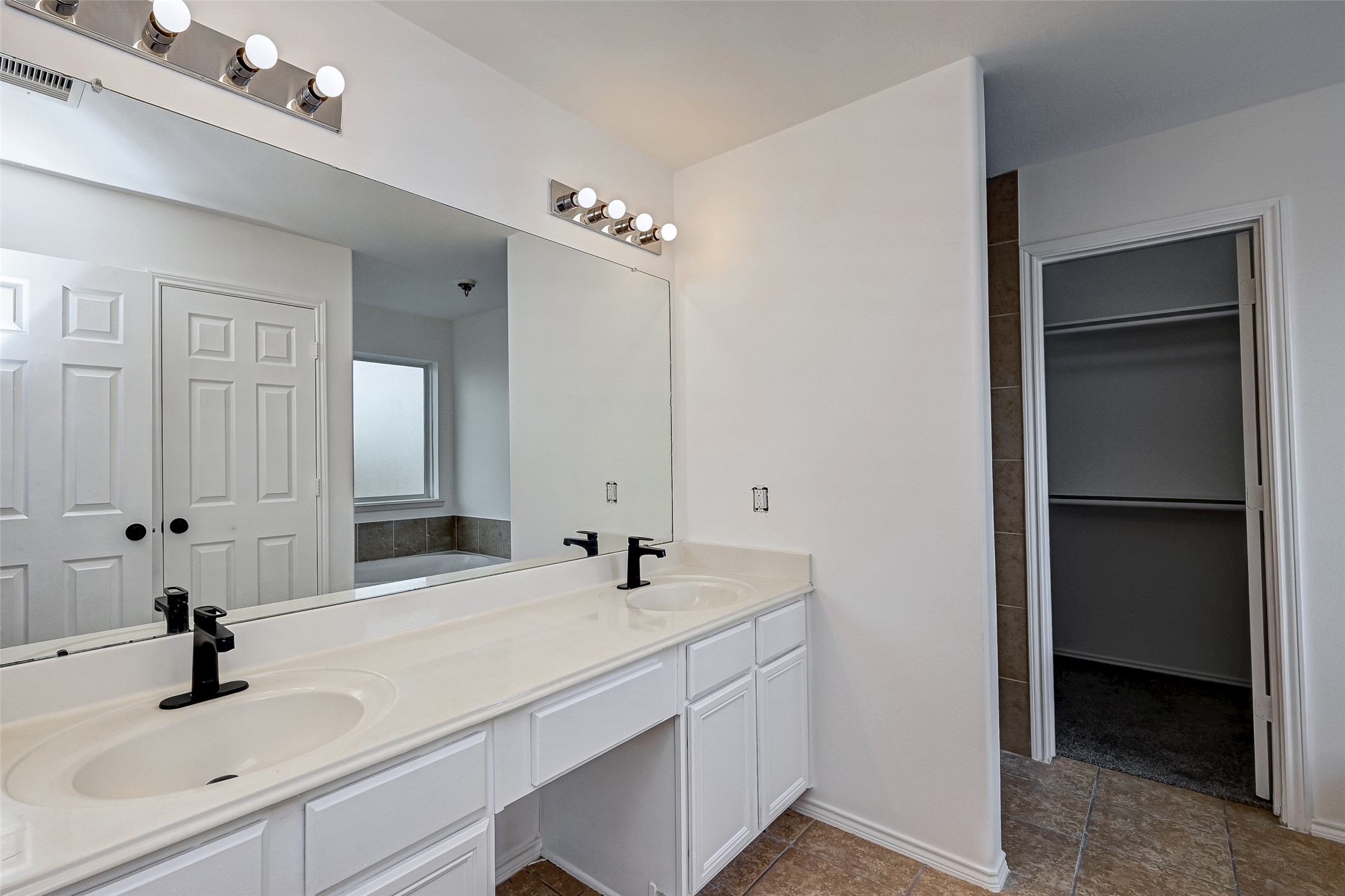 6906 Anson Point Lane Houston, TX 77040 - Photo 23 of 31 a bathroom with double vanity and a mirror