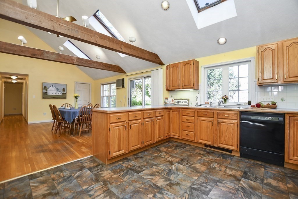 0 Cedar Street Burlington, MA 01803 - Photo 12 of 30 a kitchen with stainless steel appliances granite countertop a stove a sink dishwasher and microwave with wooden floor
