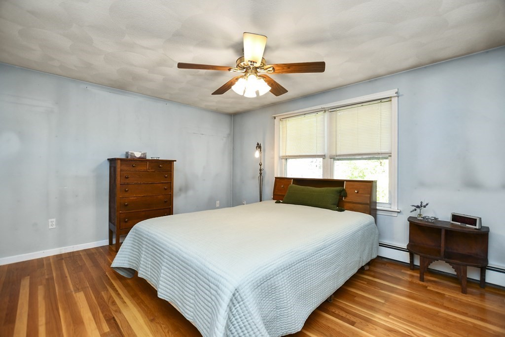 0 Cedar Street Burlington, MA 01803 - Photo 16 of 30 a bedroom with a bed and a chandelier