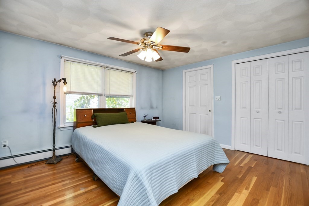 0 Cedar Street Burlington, MA 01803 - Photo 17 of 30 a bedroom with a bed and a chandelier