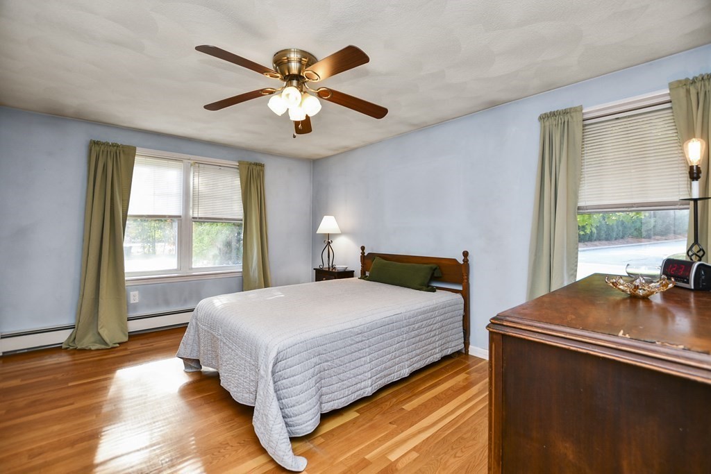 0 Cedar Street Burlington, MA 01803 - Photo 19 of 30 a bedroom with a bed and a chandelier