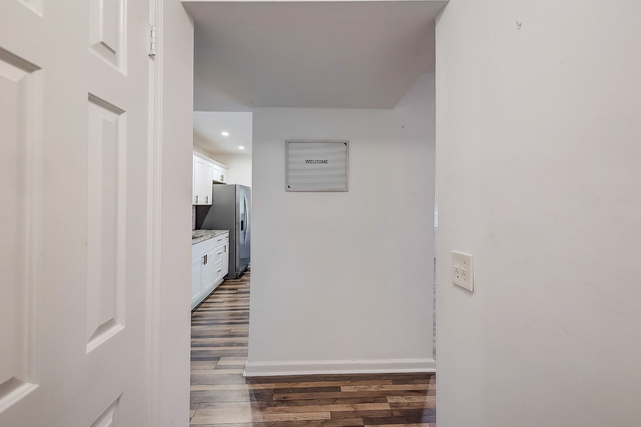 248 Manzano Road Madison, TN 37115 - Photo 3 of 27 a view of a hallway with wooden floor and staircase