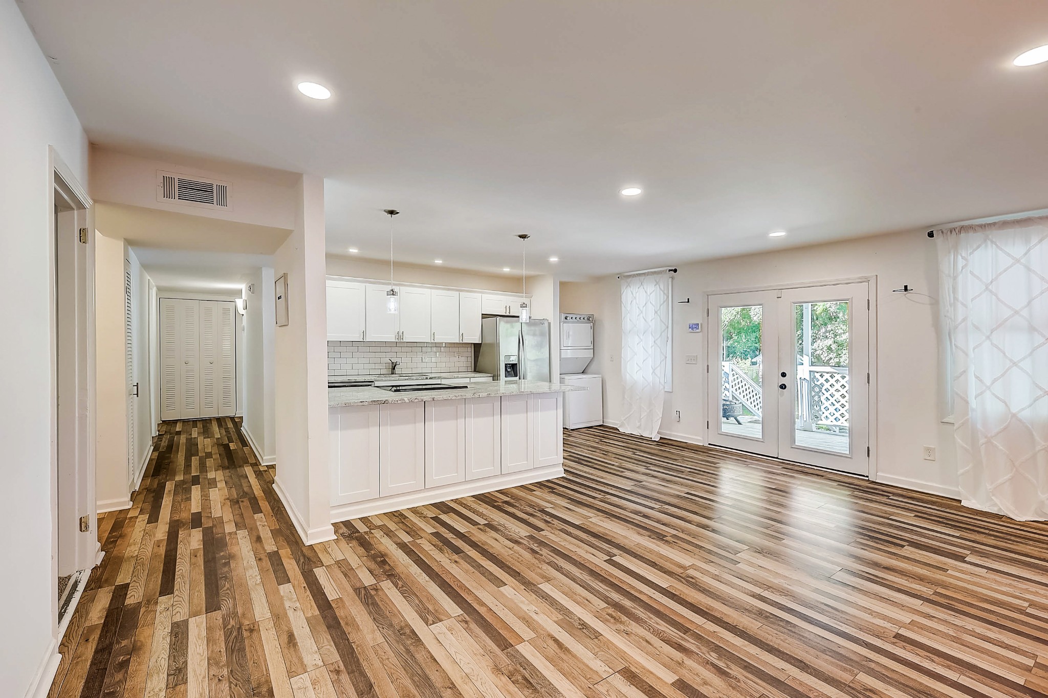 248 Manzano Road Madison, TN 37115 - Photo 4 of 27 a open kitchen with white cabinets and wooden floor