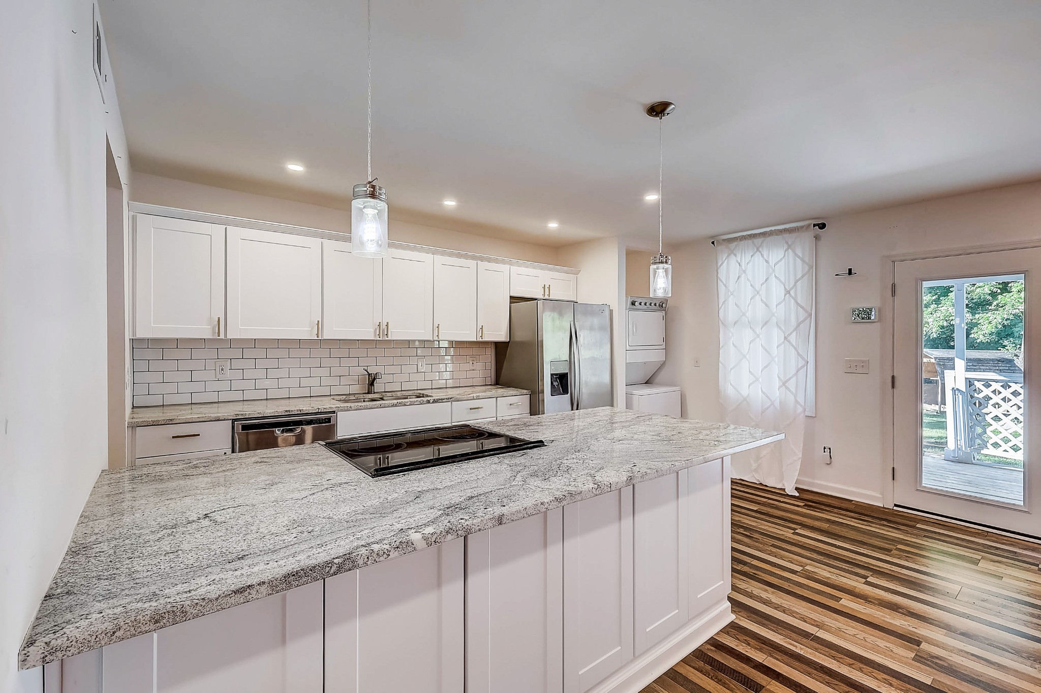 248 Manzano Road Madison, TN 37115 - Photo 9 of 27 a kitchen with stainless steel appliances granite countertop a sink and cabinets