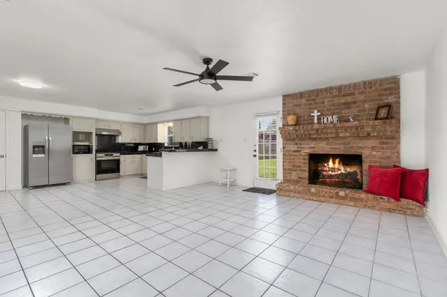 a living room with furniture a fireplace and a flat screen tv