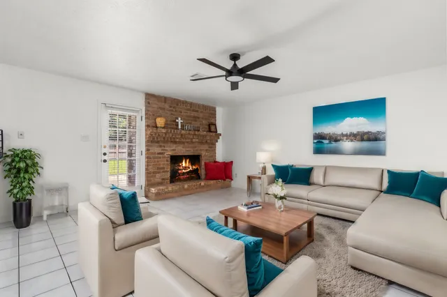 a kitchen with stainless steel appliances kitchen island granite countertop a refrigerator and white cabinets