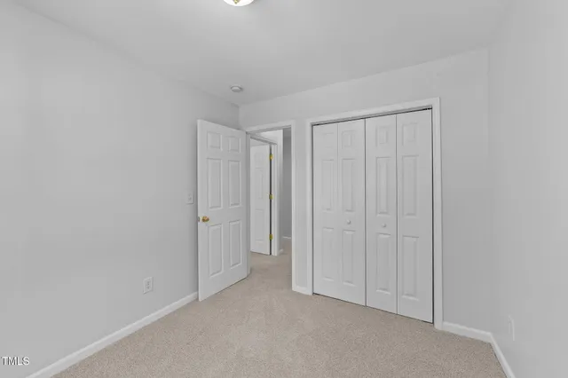 a spacious bathroom with a granite countertop sink a toilet mirror and bathtub