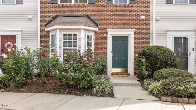 an aerial view of a house with a yard and garden