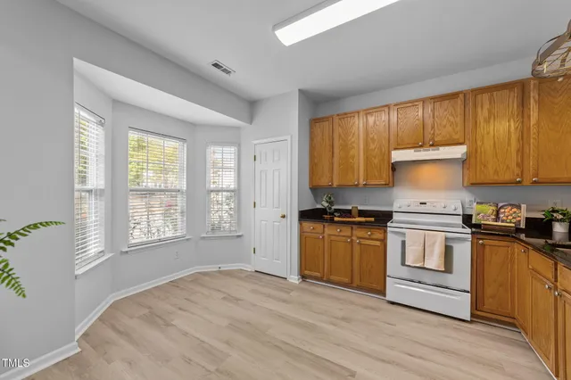 a kitchen with a stove a sink and a refrigerator