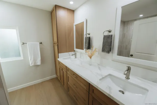 a bathroom with a double vanity sink and a mirror