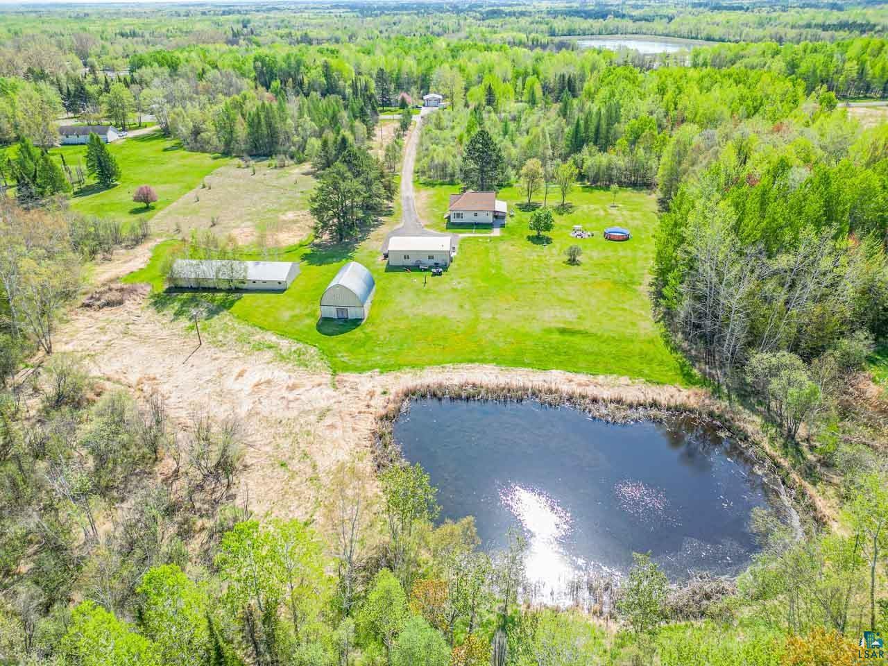 2581 O'Rourke Road Hibbing, MN 55746 - Photo 55 of 61 Aerial perspective showcasing a property with a private pond and surrounding green landscape