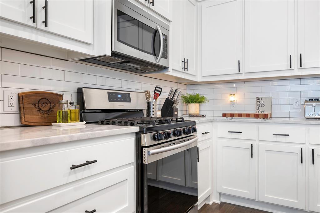 312 North Henderson Avenue, Unit 1 Dallas, TX 75214 - Photo 12 of 25 a kitchen with white cabinets and appliances