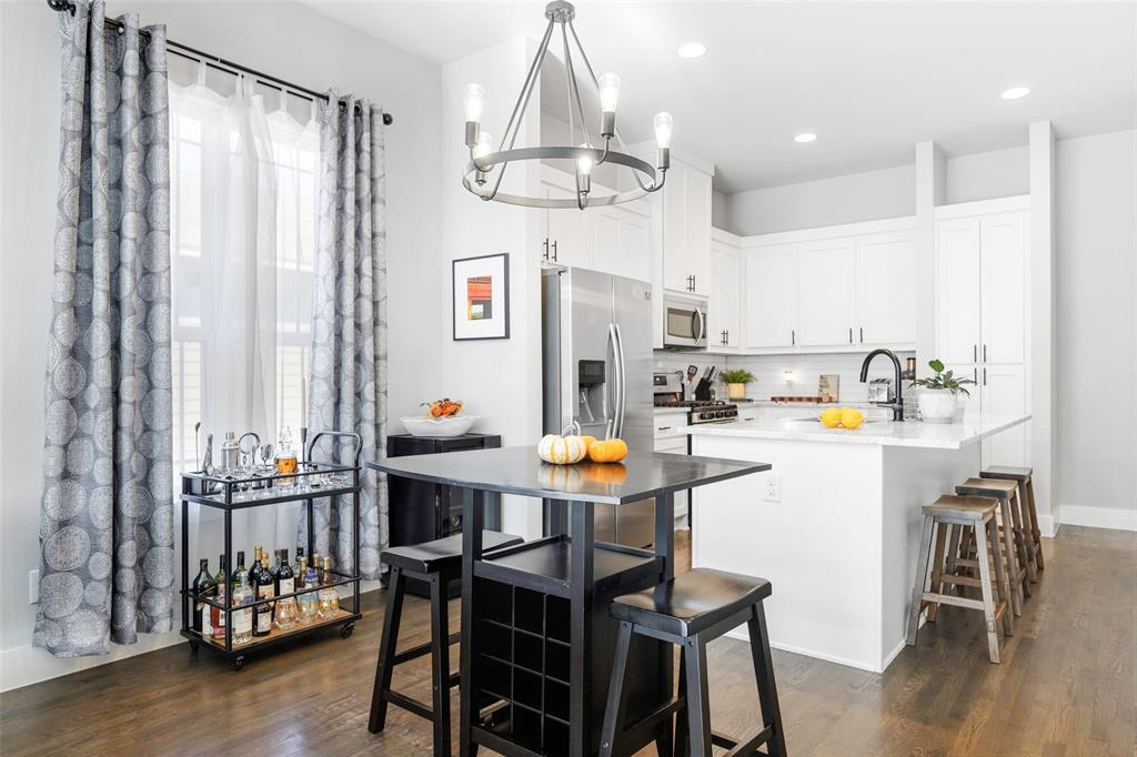 312 North Henderson Avenue, Unit 1 Dallas, TX 75214 - Photo 16 of 25 a view of a dining room with furniture and chandelier