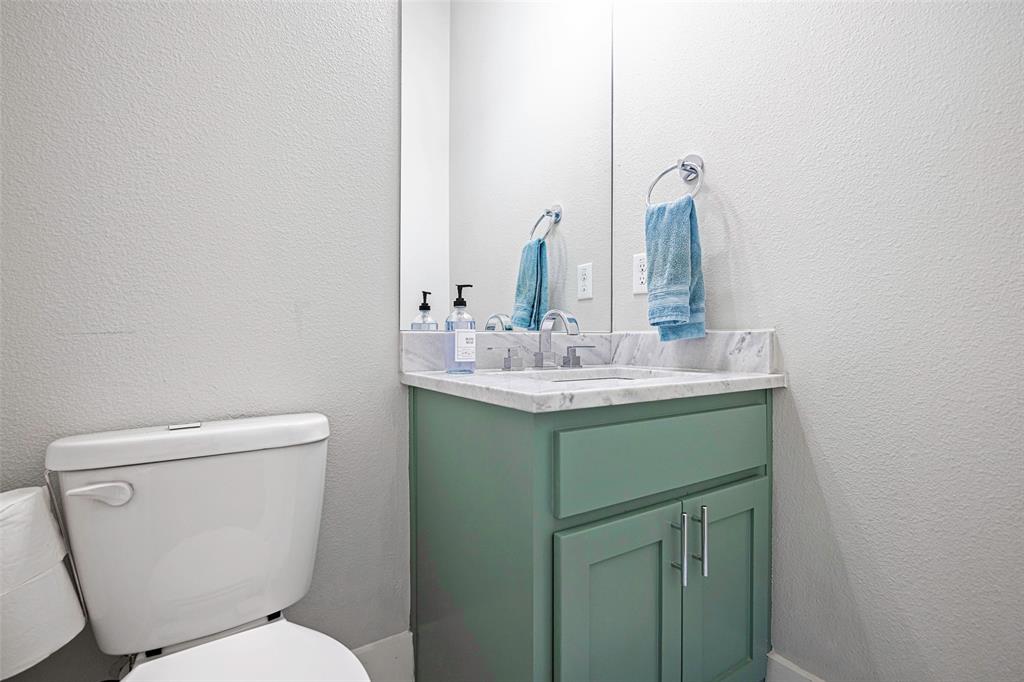 312 North Henderson Avenue, Unit 1 Dallas, TX 75214 - Photo 23 of 25 a bathroom with a toilet sink and mirror