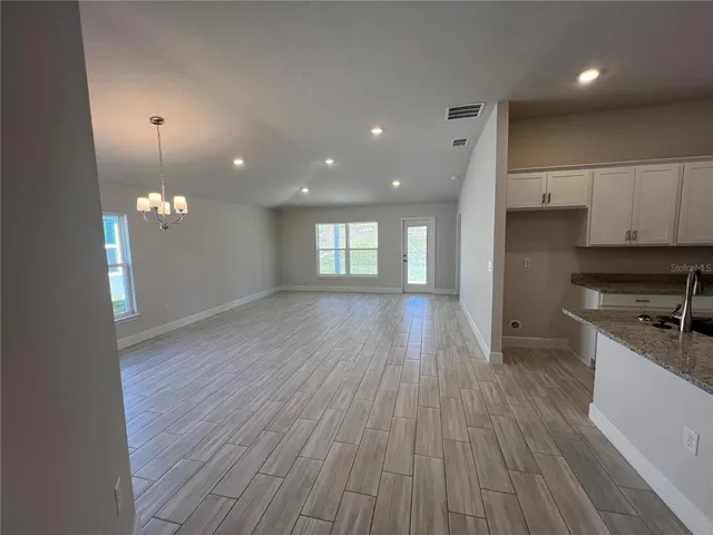a view of a kitchen with a sink and wooden floor