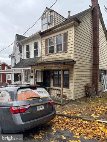 a front view of a house with parking space