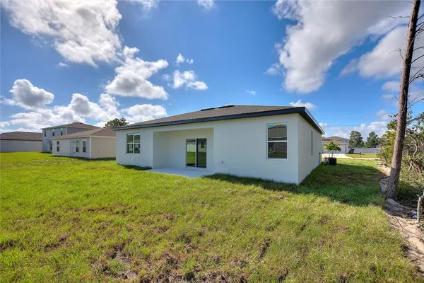 a backyard of a house with lots of green space and mountain view