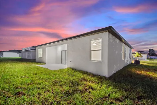 a view of a house with a backyard