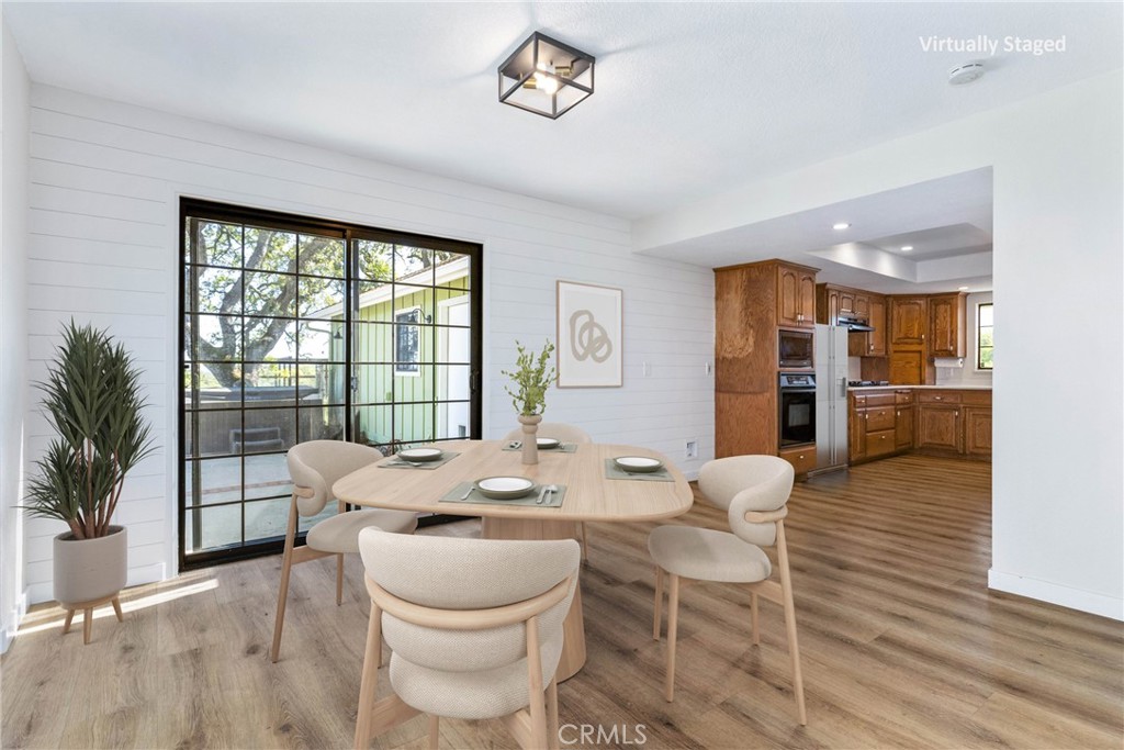 10870 Santa Ana Road Atascadero, CA 93422 - Photo 17 of 67 The dining area offers vinyl plank flooring, shiplap walls and a sliding glass door that leads out to the patio. Photo has been virtually staged.