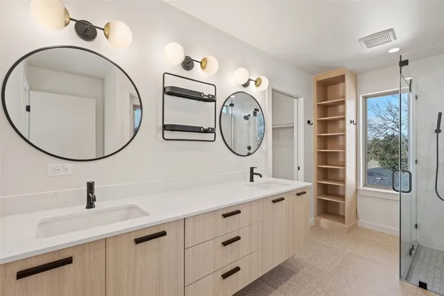 a bathroom with a sink double vanity and a mirror