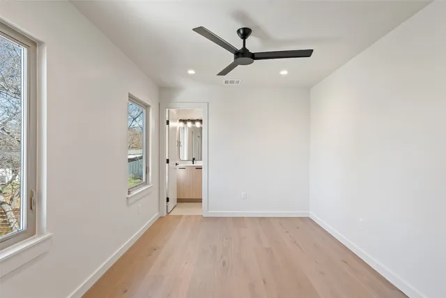 a view of a livingroom with a hardwood floor and a ceiling fan