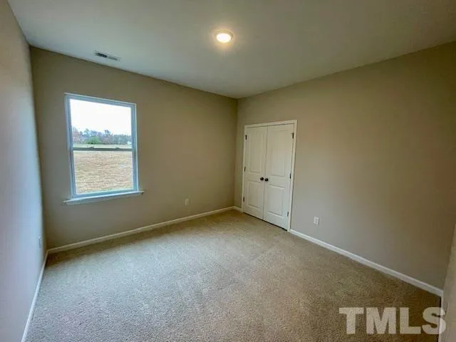 an empty room with a empty space and windows