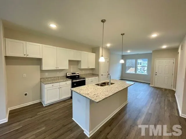a kitchen with a sink and stove top oven