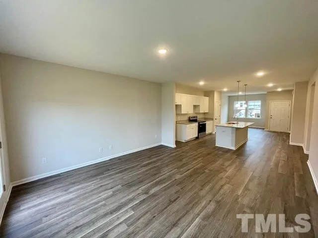 a view of a kitchen with a sink and a refrigerator