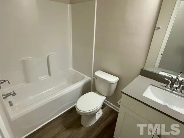 a white toilet sitting next to a bath tub