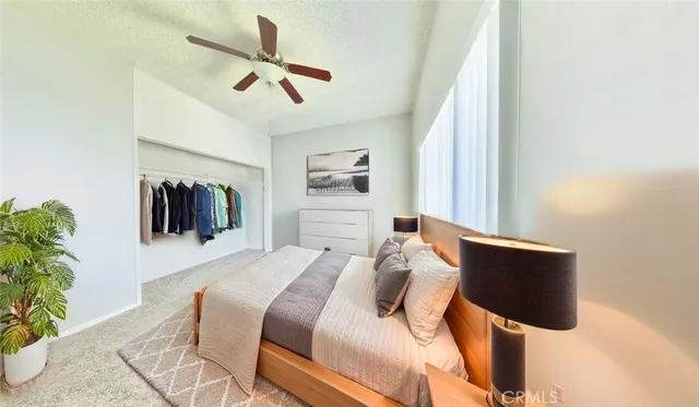 a bedroom with a bed and a painting on the wall