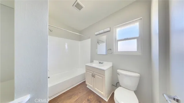 a bathroom with a toilet a sink and bathtub