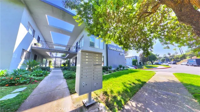 a view of a house with a yard and pathway