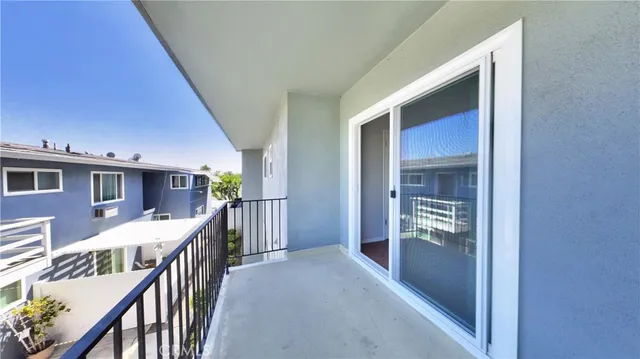 a view of a hallway to a livingroom with furniture
