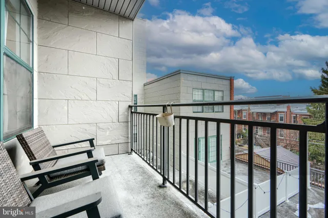 a view of a chairs and table in the balcony