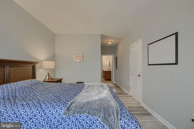 a bedroom with a bed and painting on the wall