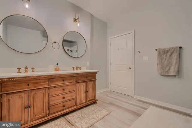 a bathroom with a double vanity sink and a mirror