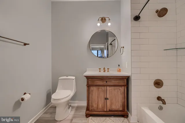 a bathroom with a toilet a sink and mirror