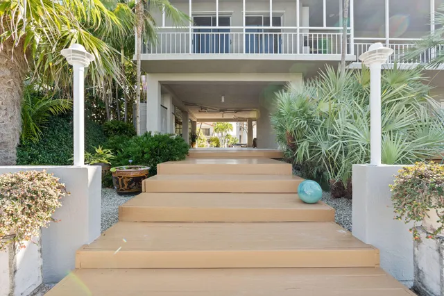 a view of a livingroom with furniture a ceiling fan and wooden floor