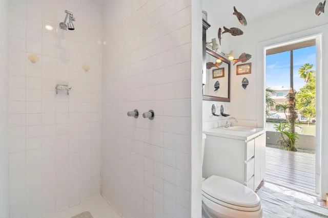a dining area with furniture a chandelier and kitchen view