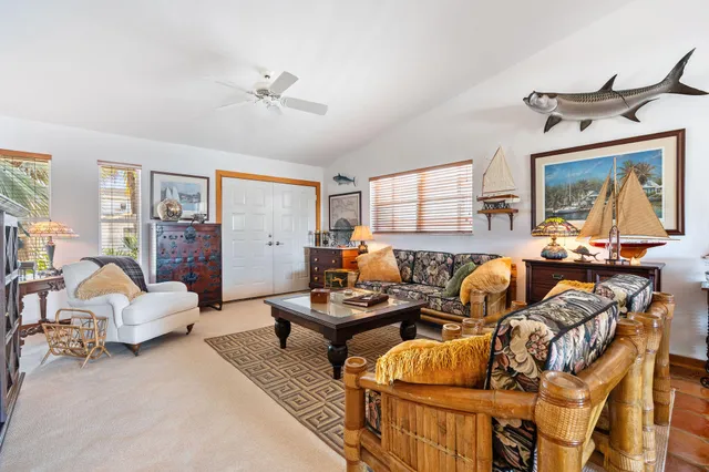 a kitchen with stainless steel appliances granite countertop a stove top oven a sink a dining table and chairs with wooden floor